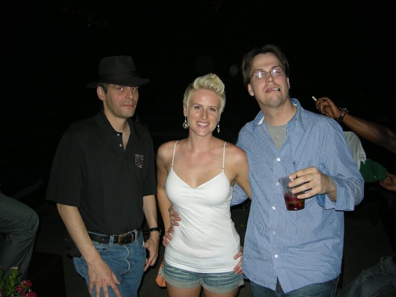Three people at a nighttime gathering