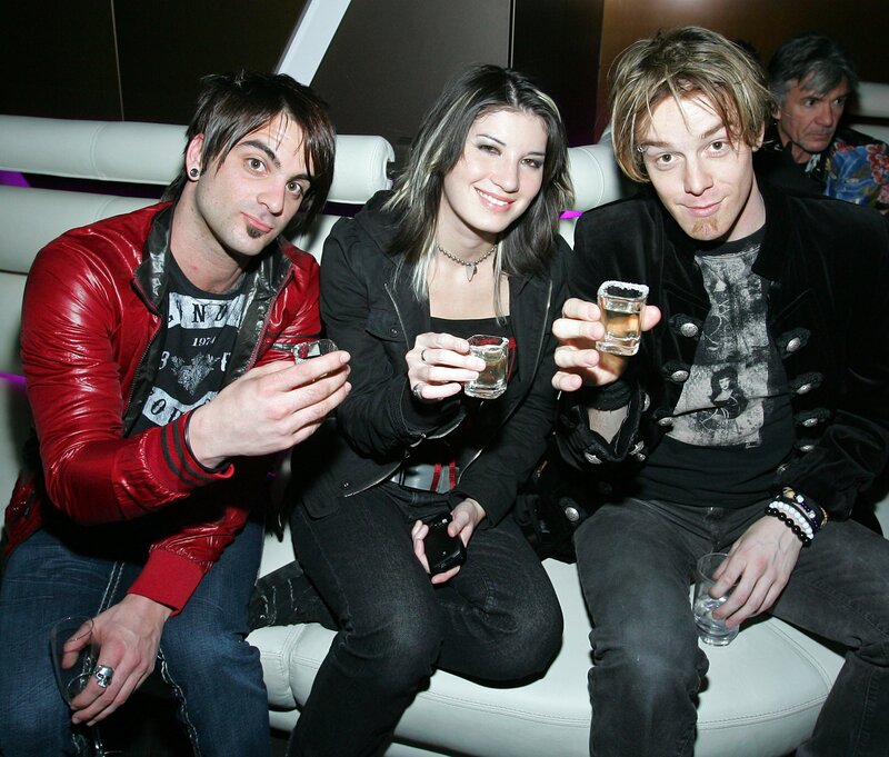 Three people at a party with drinks