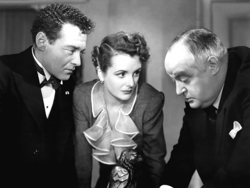 Three people examining an object