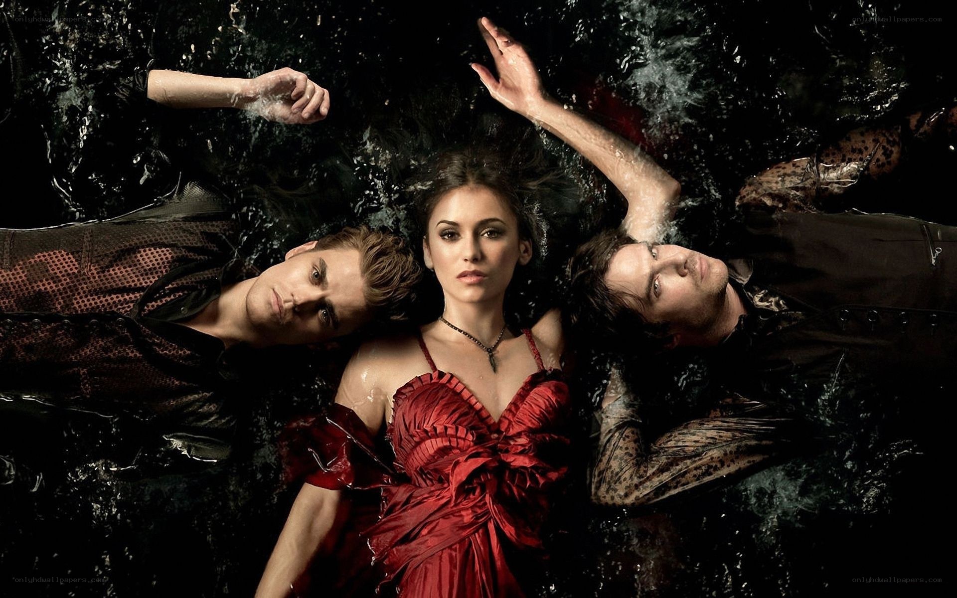 three people floating in water