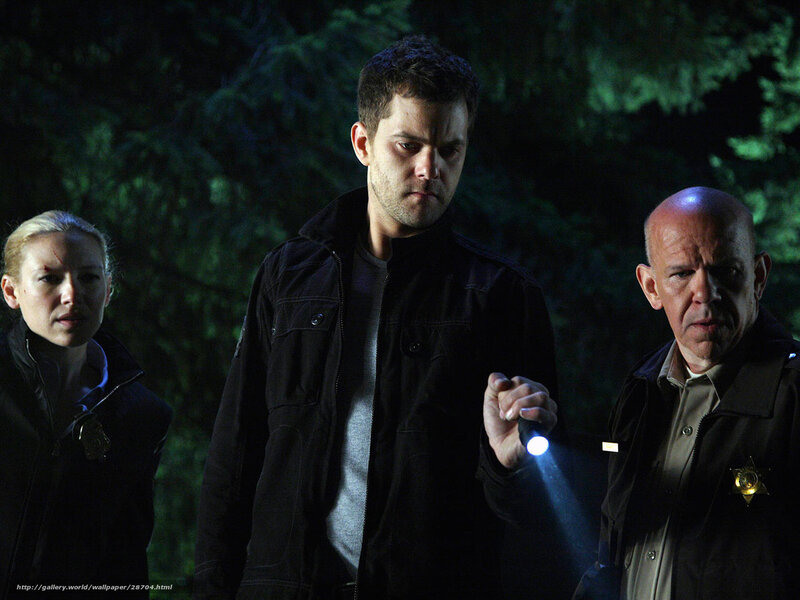 Three people in a dark forest