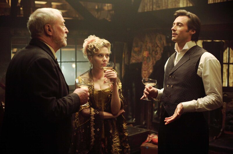 Three people in a dimly lit room