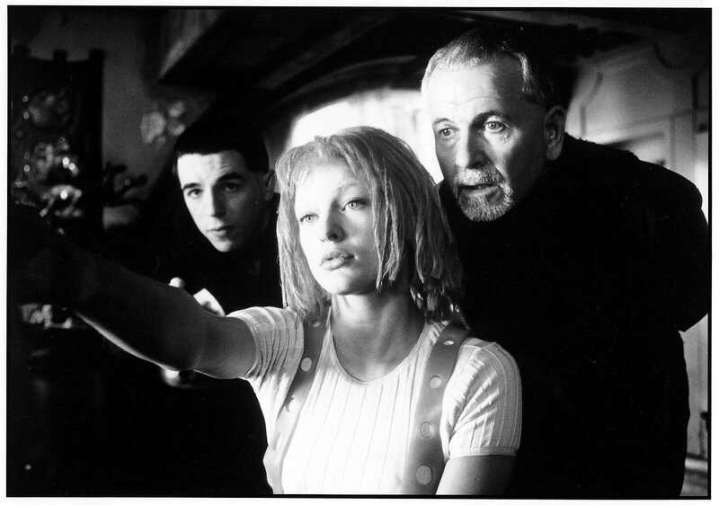 Three people in a dimly lit room