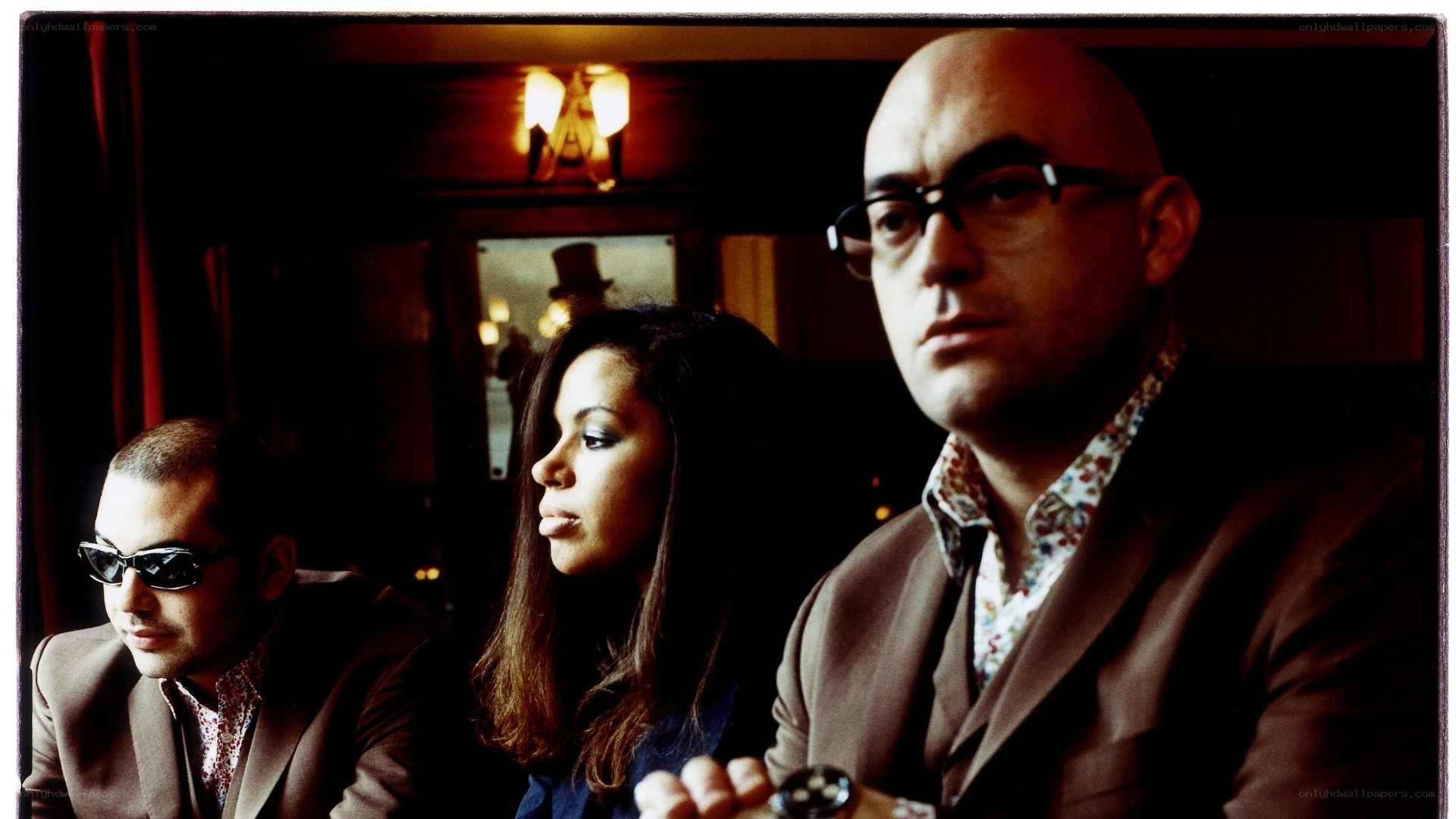 three people in a dimly lit room