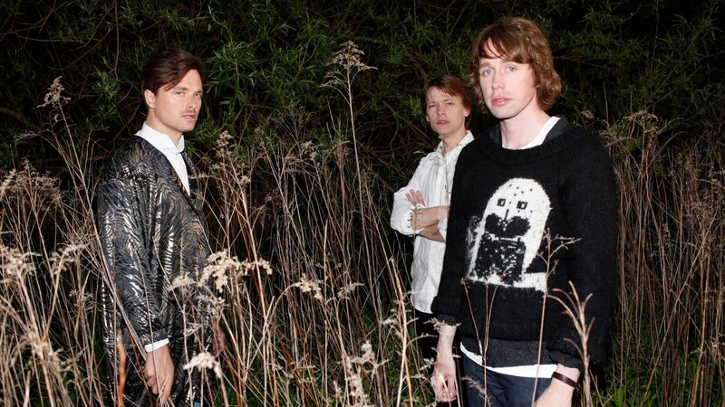 three people in a field at night