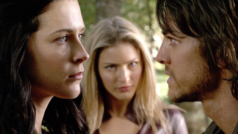 three people in a forest scene