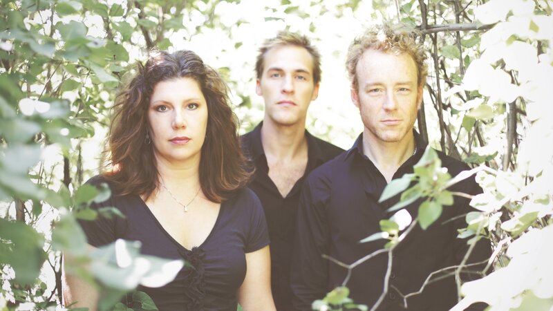 three people in a forest