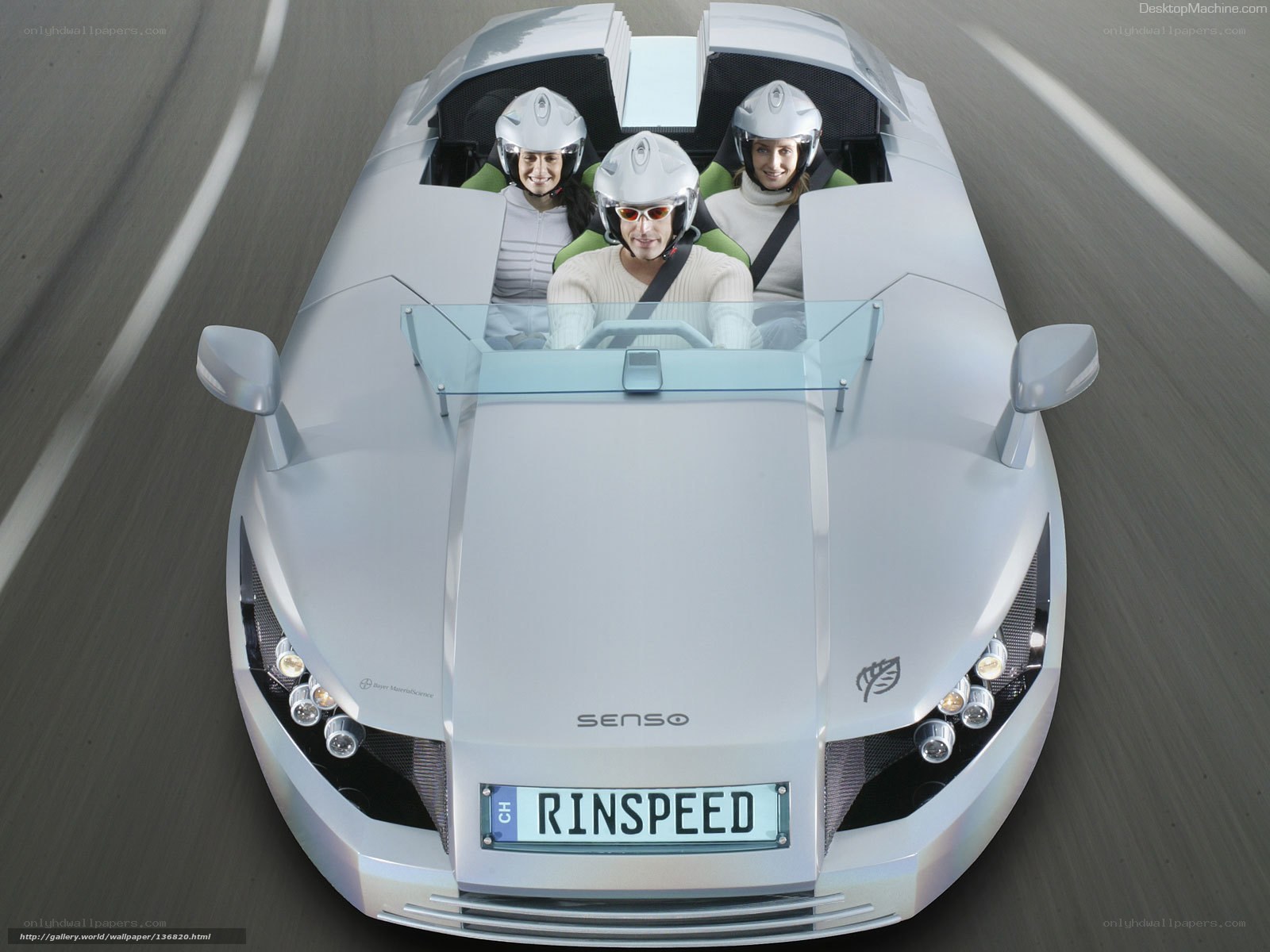 Three people in a futuristic car