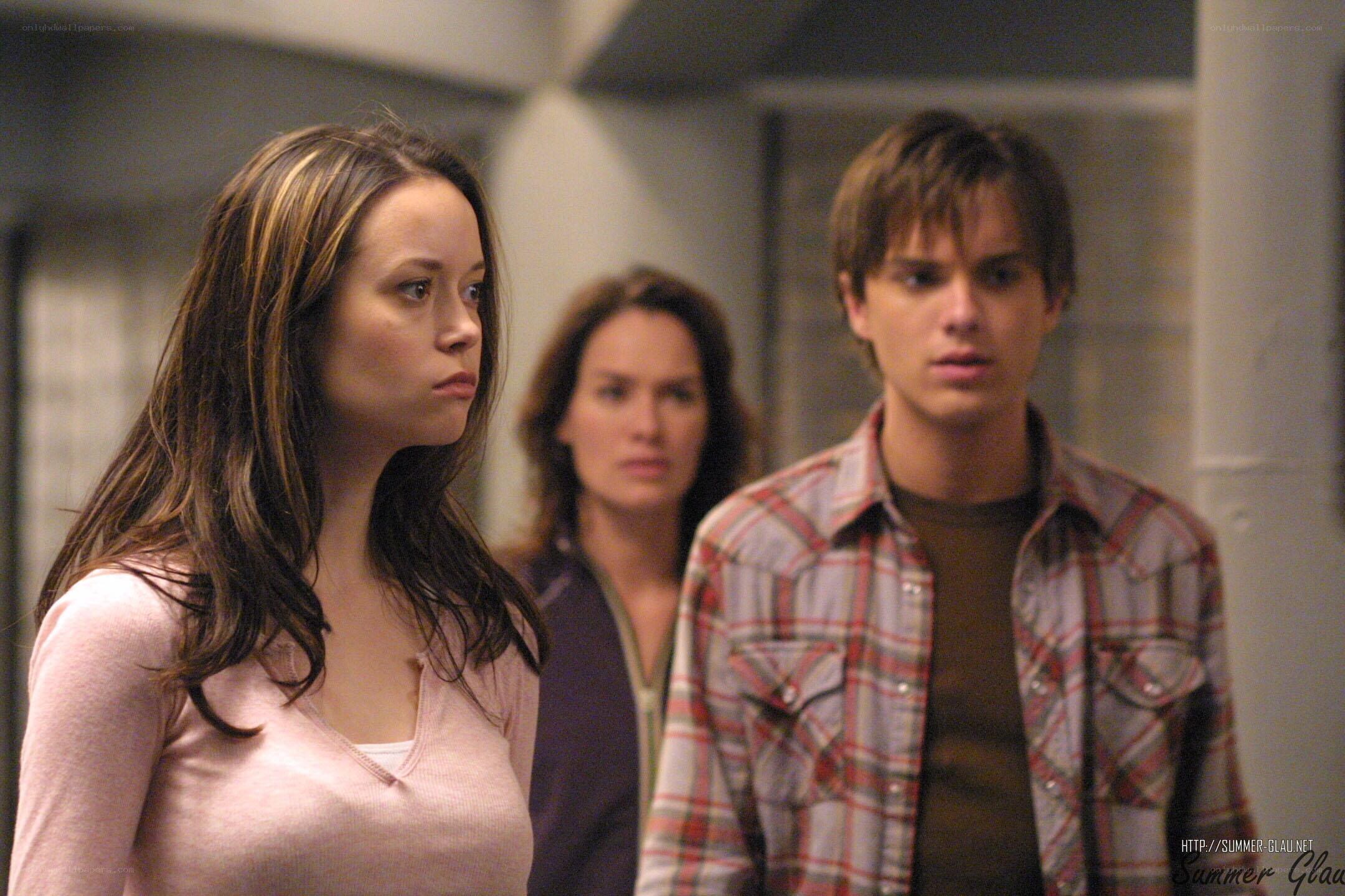 three people in a hallway