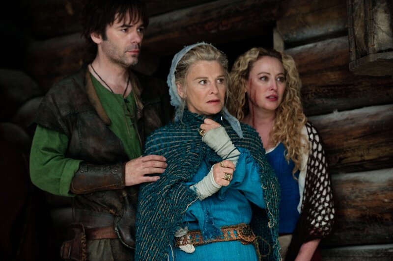 Three people in a wooden cabin