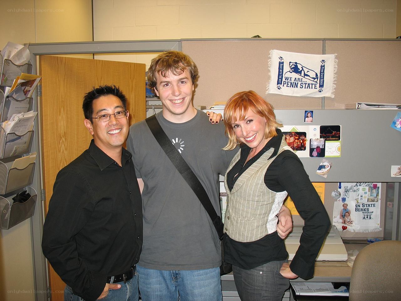 Three people in an office cubicle
