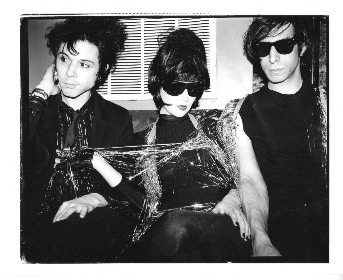 Three people in black and silver