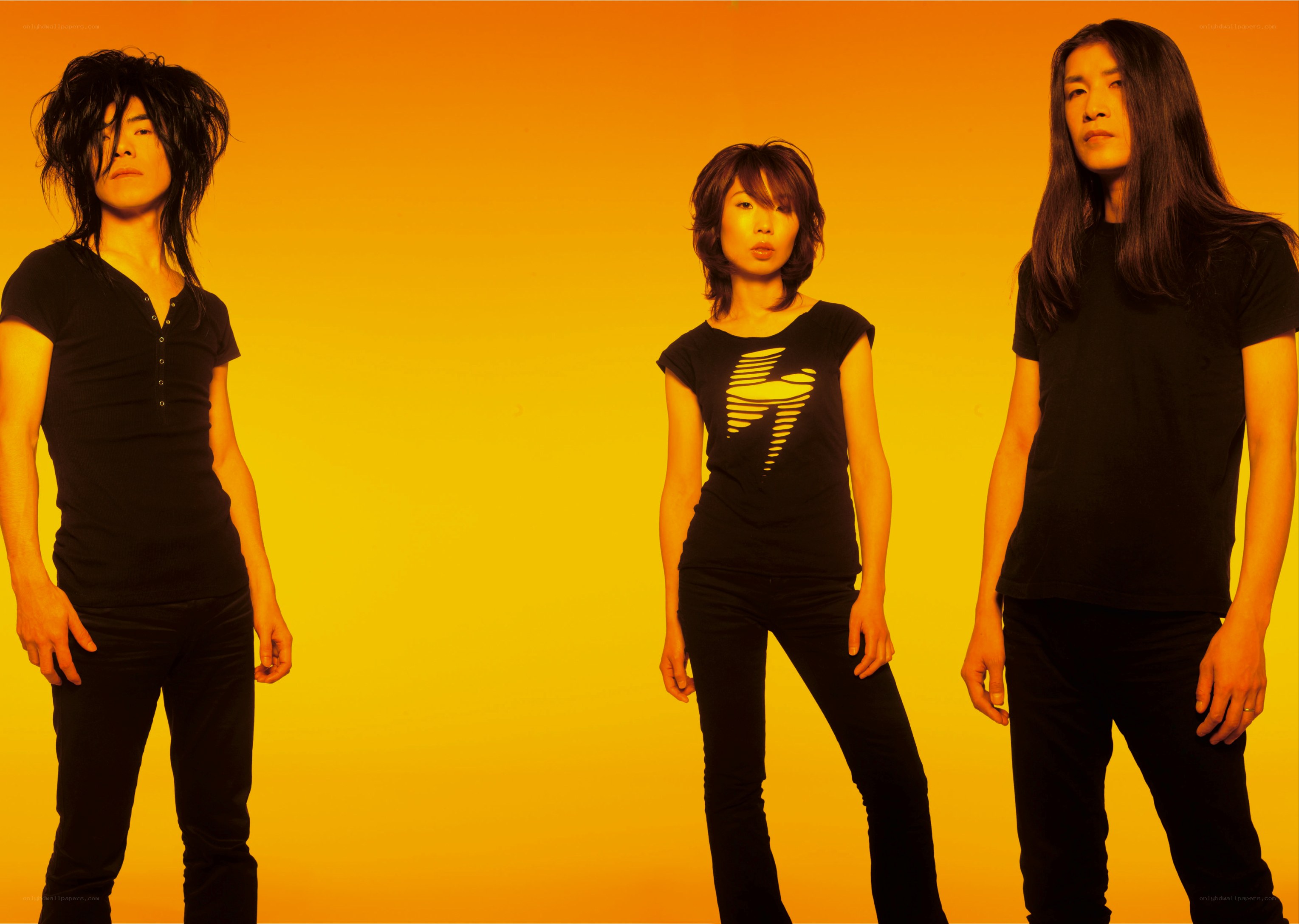 three people in black on orange background