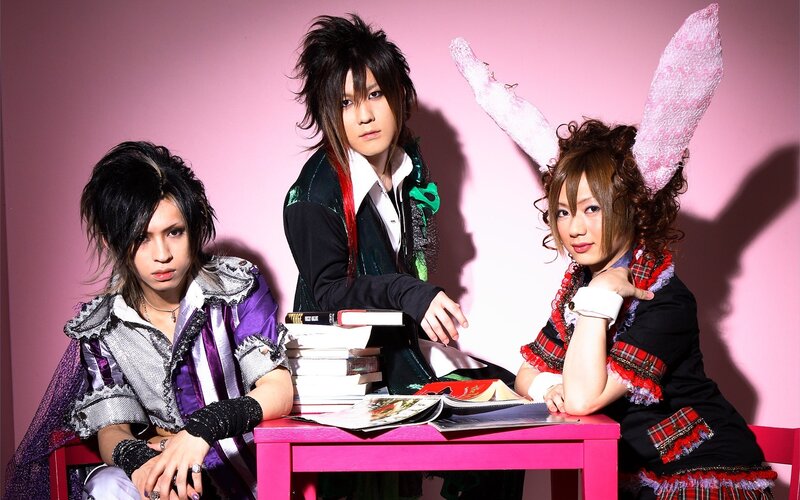 three people in colorful costumes
