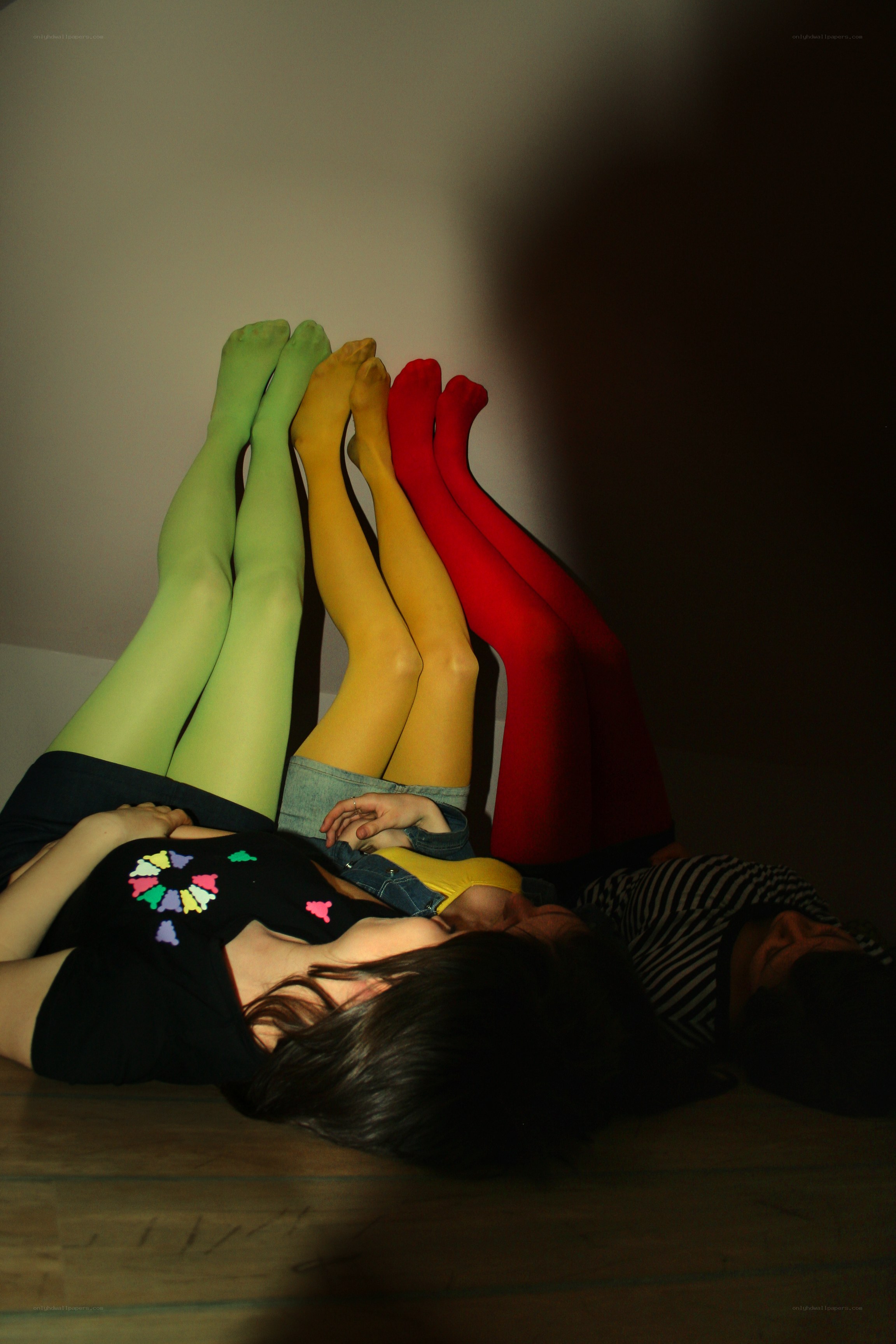 three people in colorful tights
