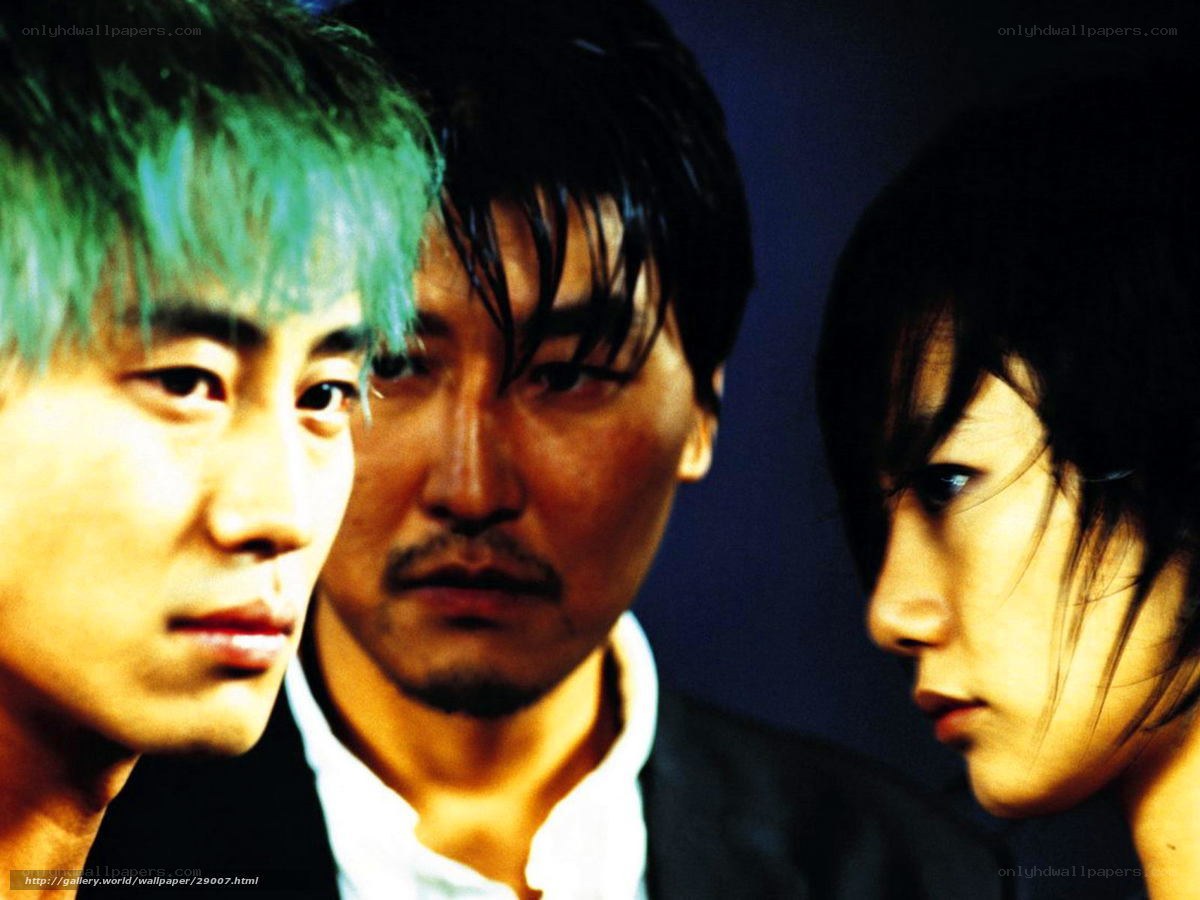 Three people in dramatic lighting