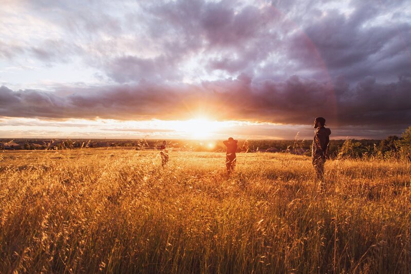 Three People in Field — Gold