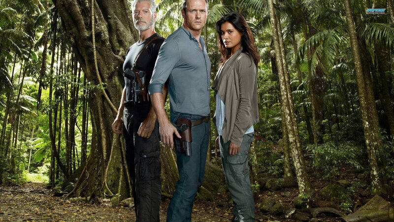 three people in jungle with guns