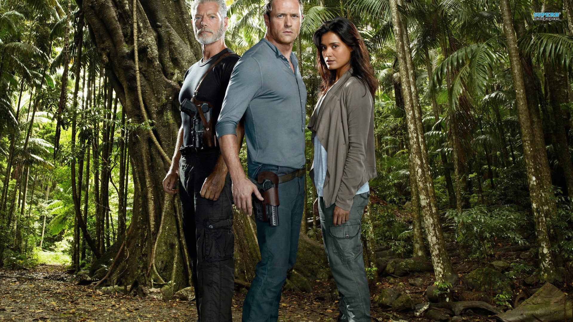 three people in jungle with guns