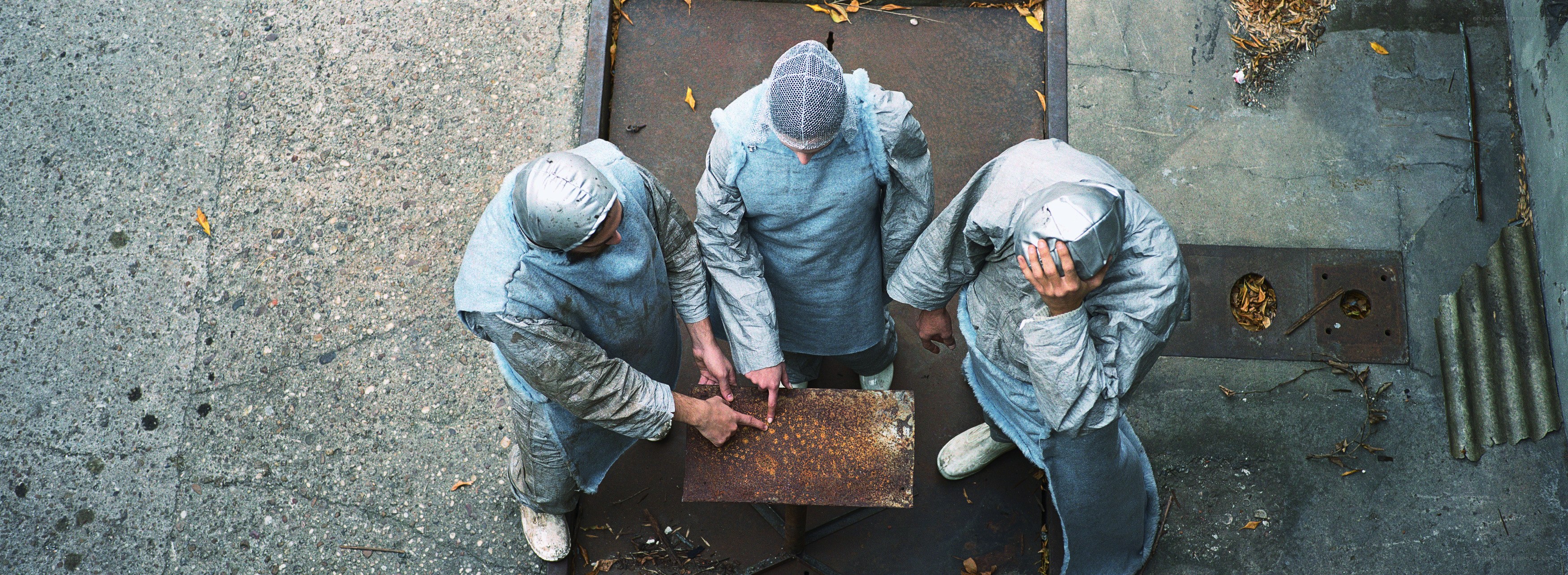 three people in protective suits