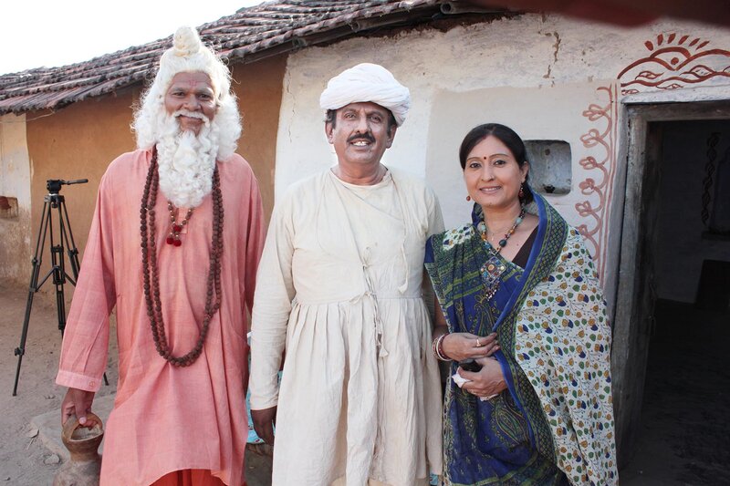 Three People in Traditional Clothing — White