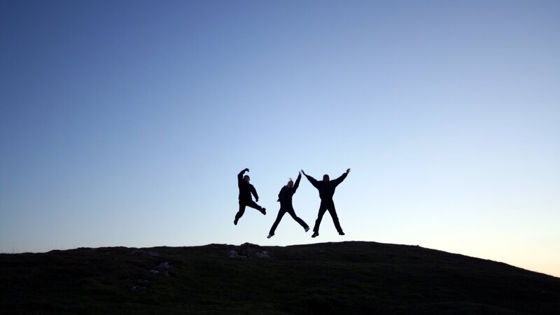 Three People Jumping — Blue