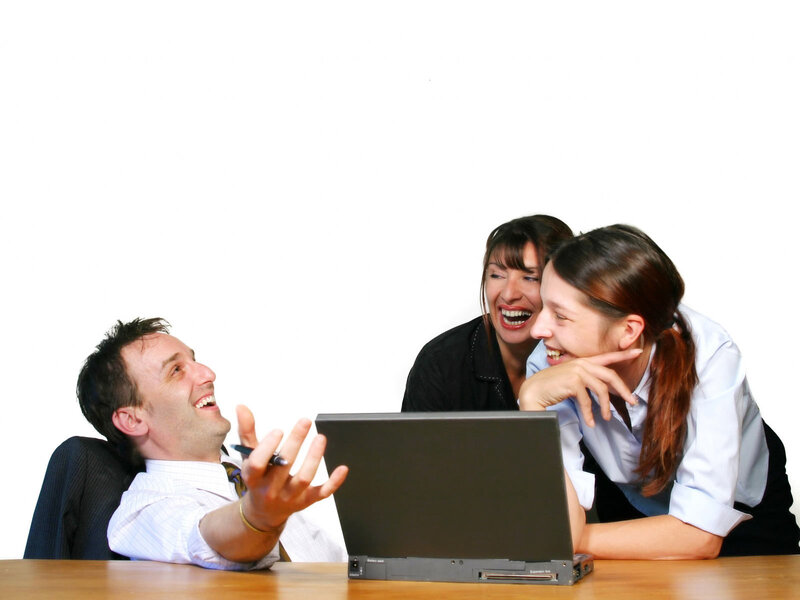 Three People Laughing at Laptop