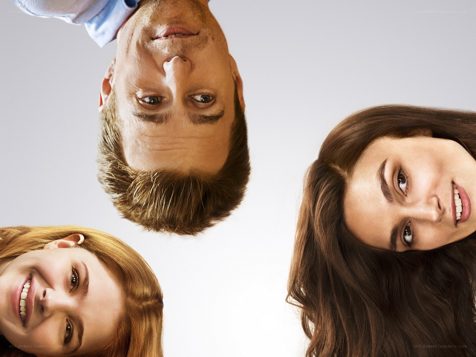 three people looking down