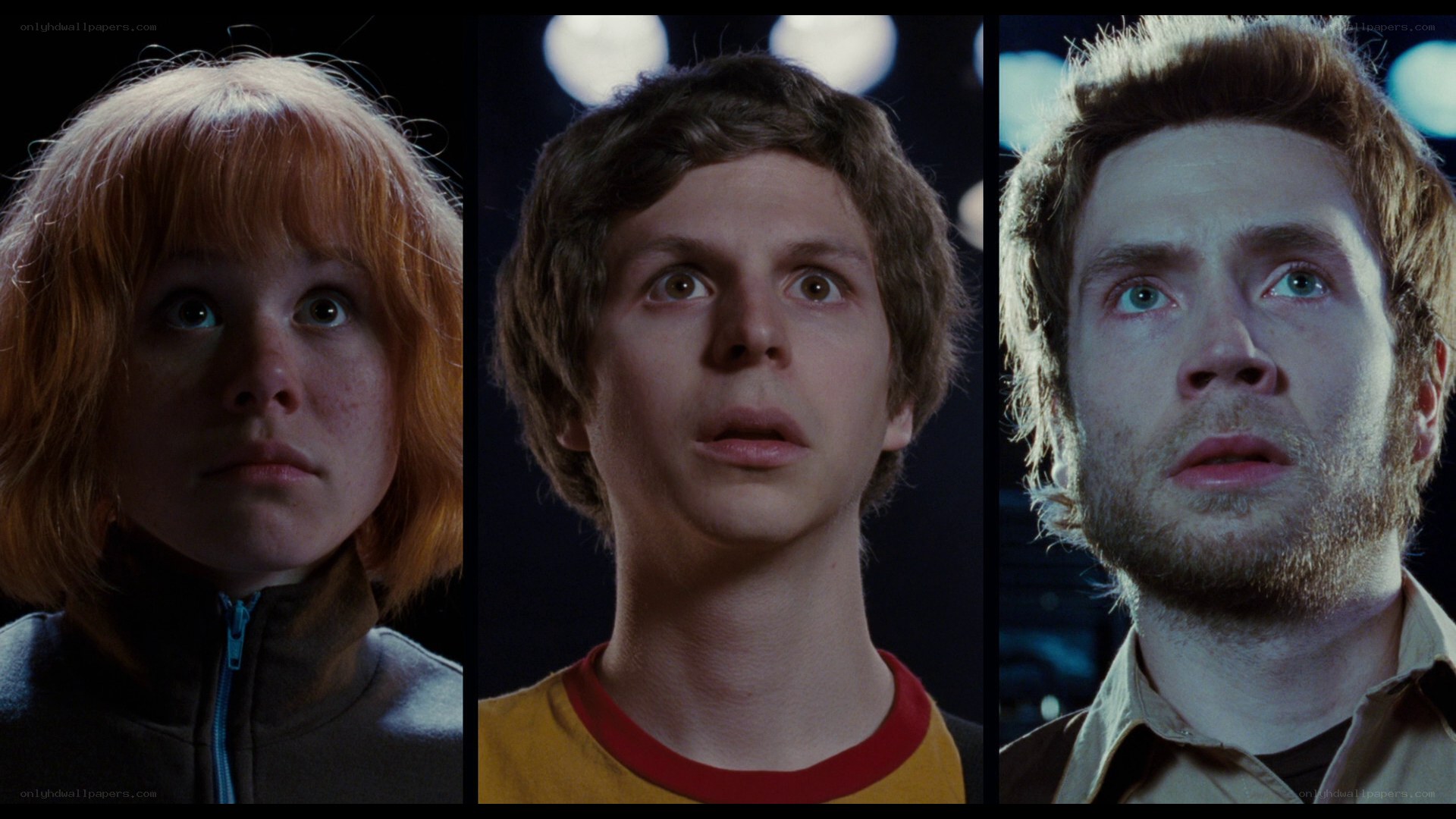 three people looking up in awe