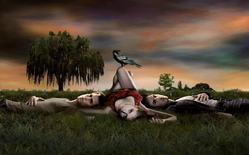 three people lying in a field