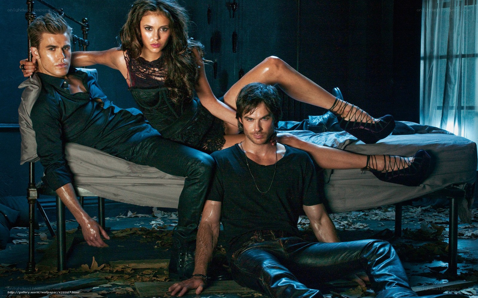 three people on a bed