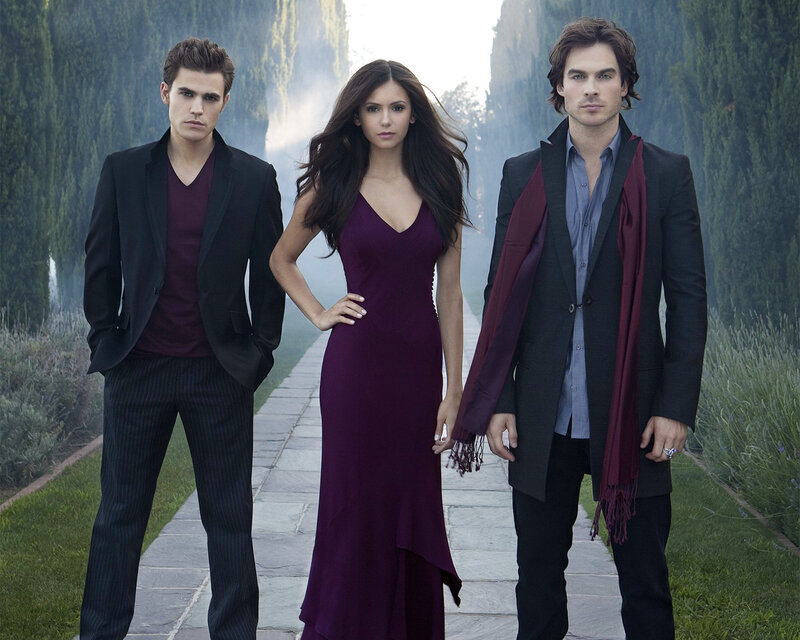three people on a garden path