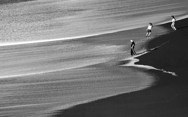 Three People on Beach — Black, Serene