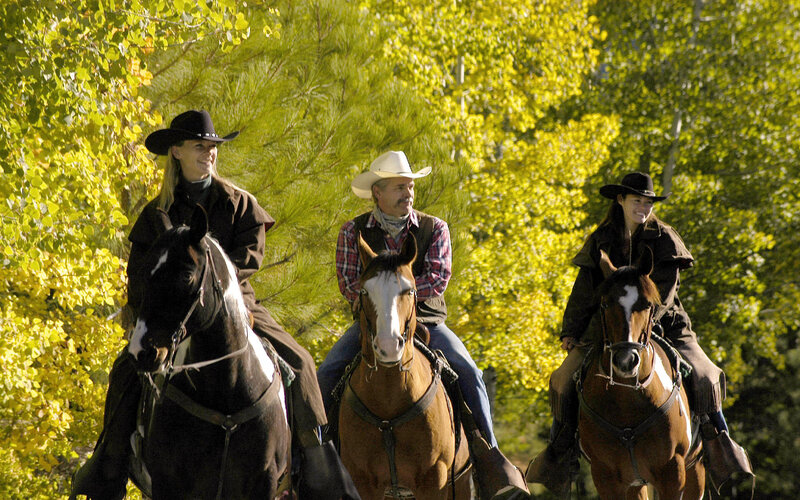 Three People on Horses — Green