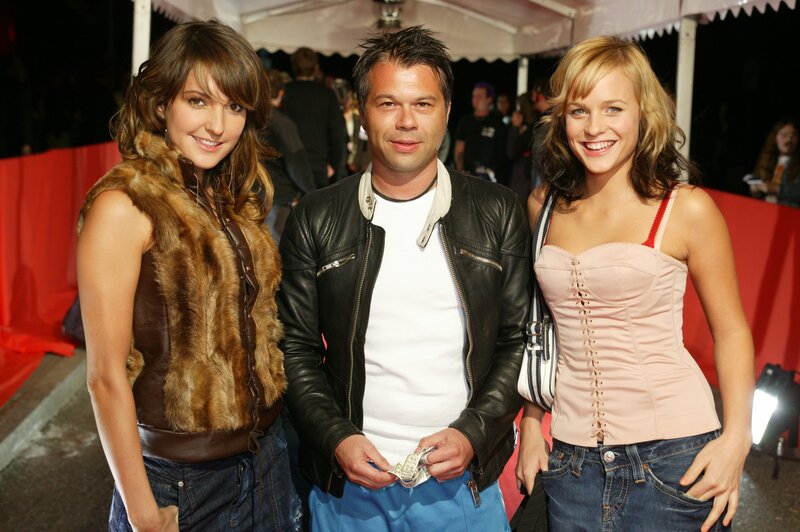 Three people on red carpet