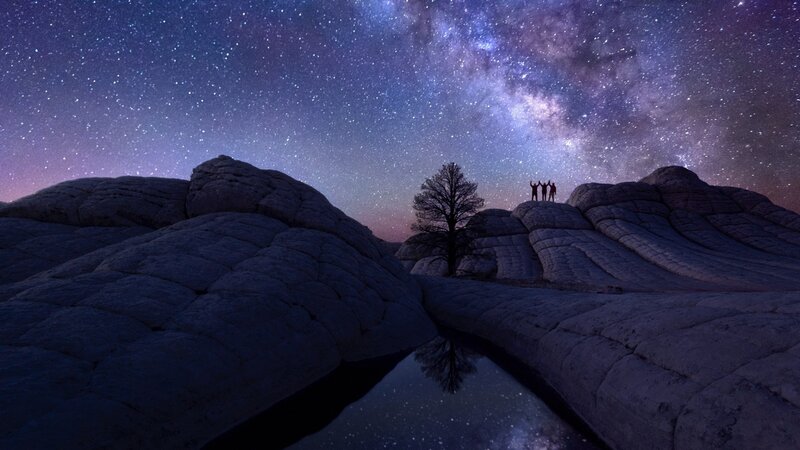 Three People on Rock Formation
