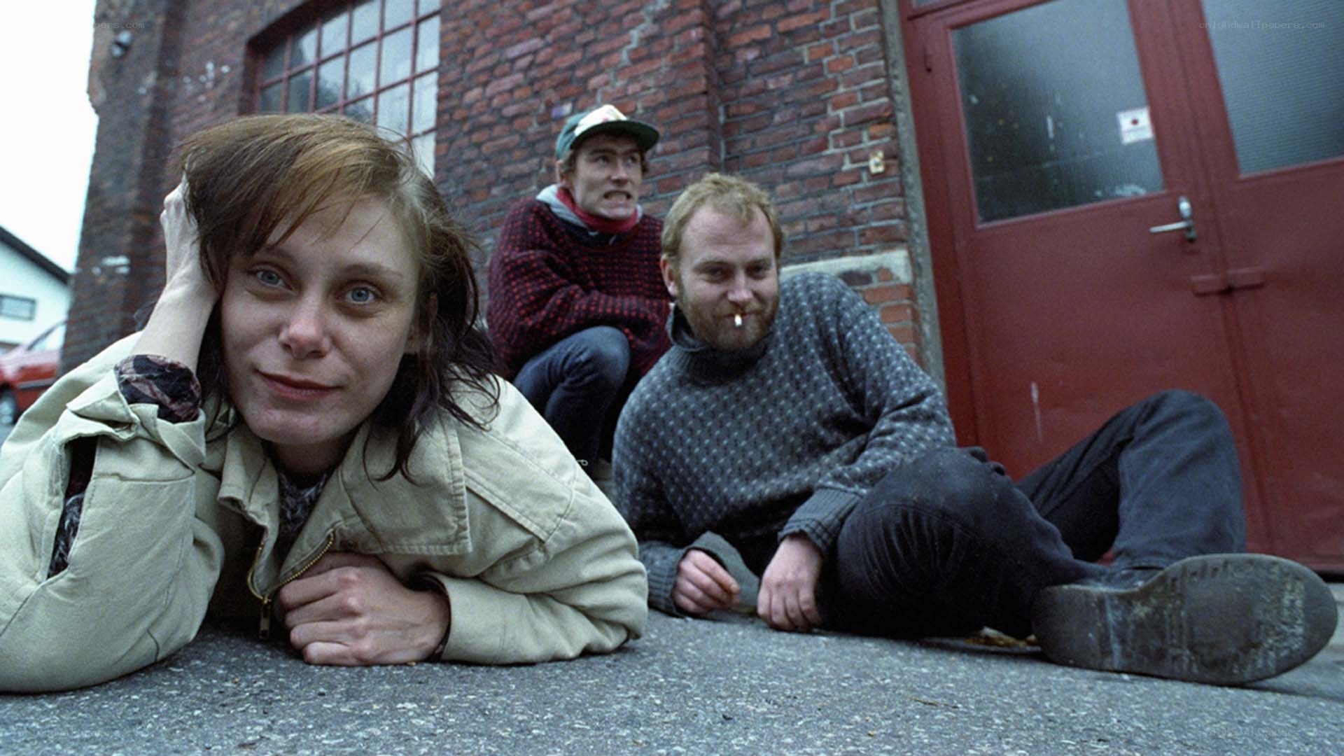 Three people on the ground outside