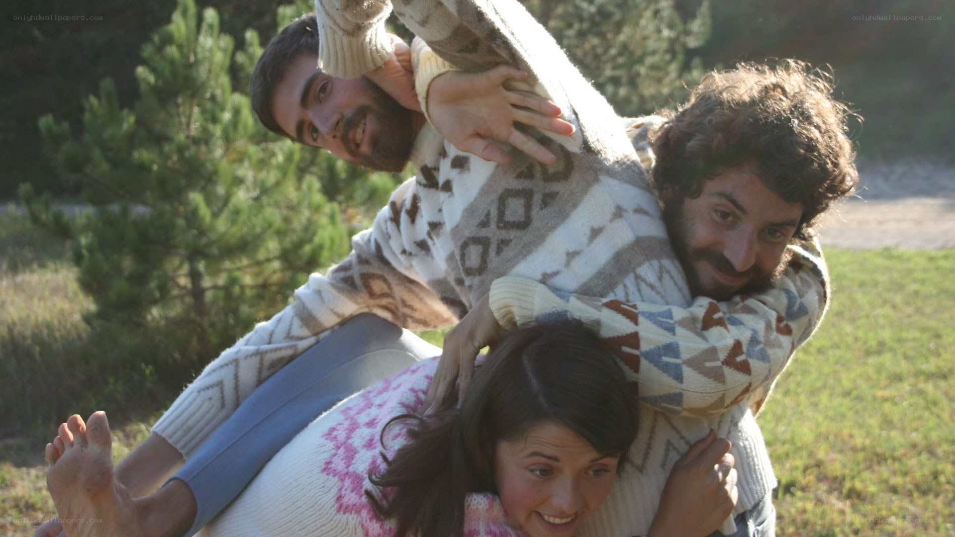 Three people playing outdoors