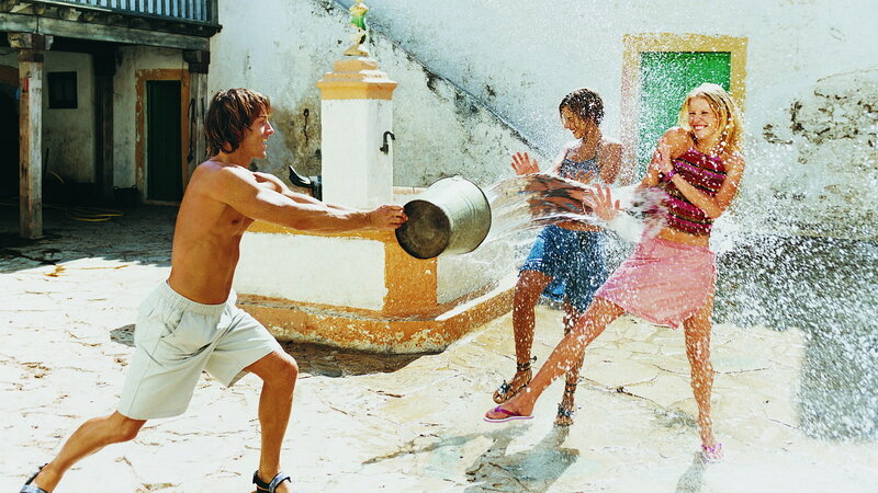 Three People Playing with Water