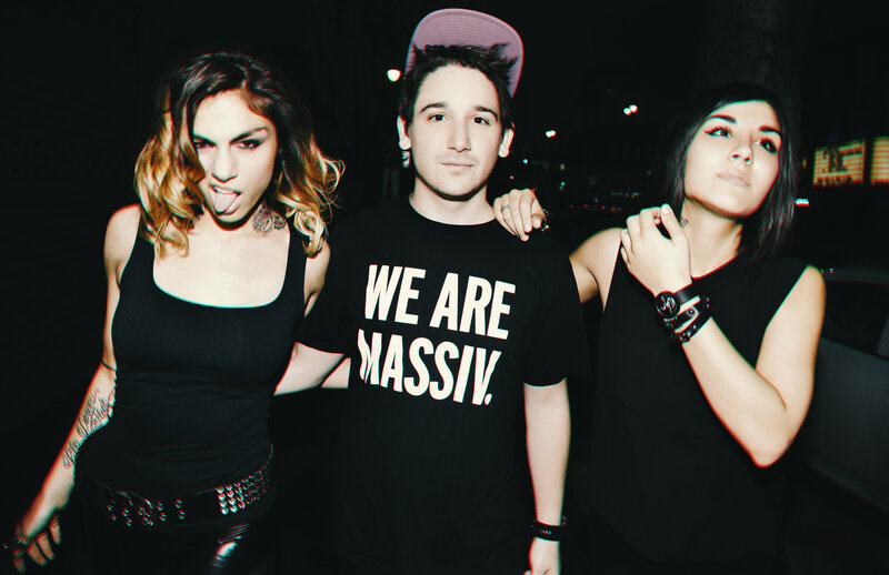Three People Posing at Night