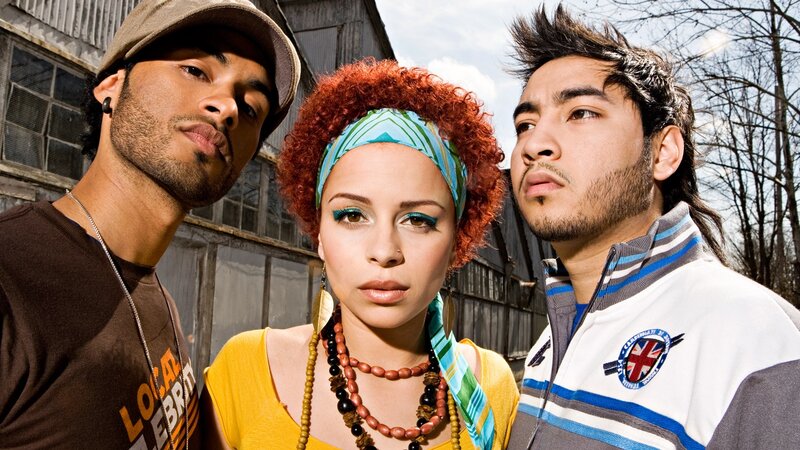 three people posing outdoors