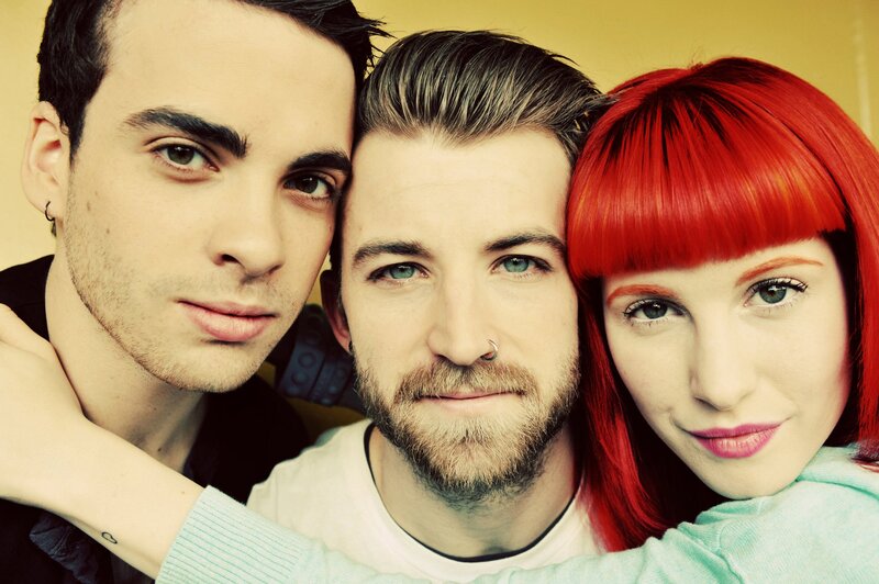 Three People Posing Together — Red, Neutral