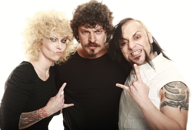 three people posing with rock gestures