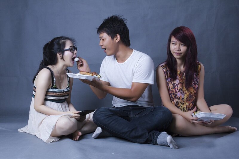 Three people sharing food