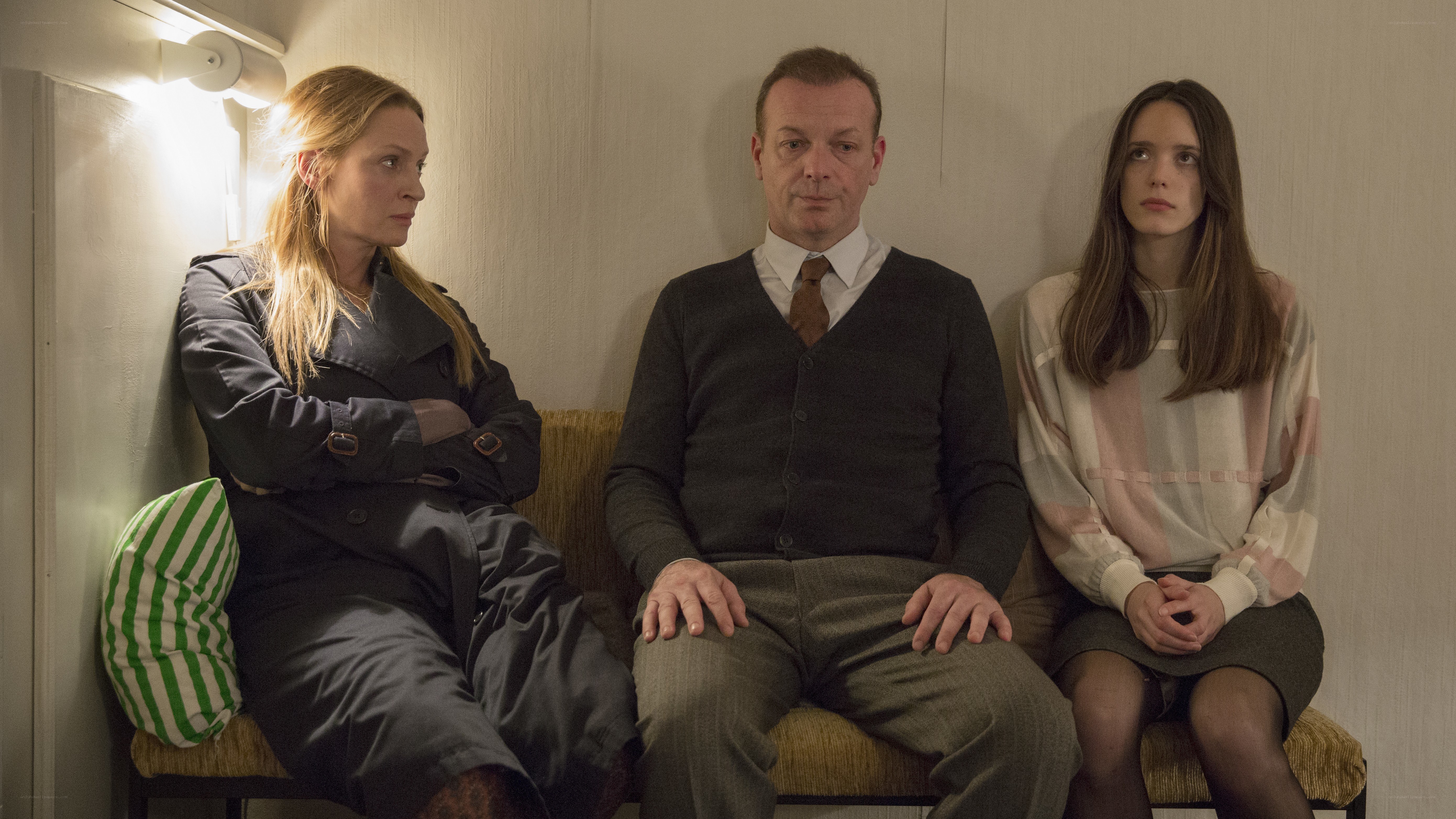 Three people sitting on a bench