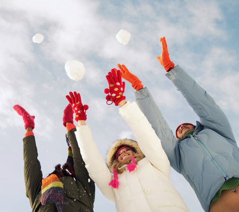 Three People Throwing Snowballs