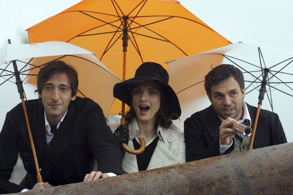 Three people under umbrellas