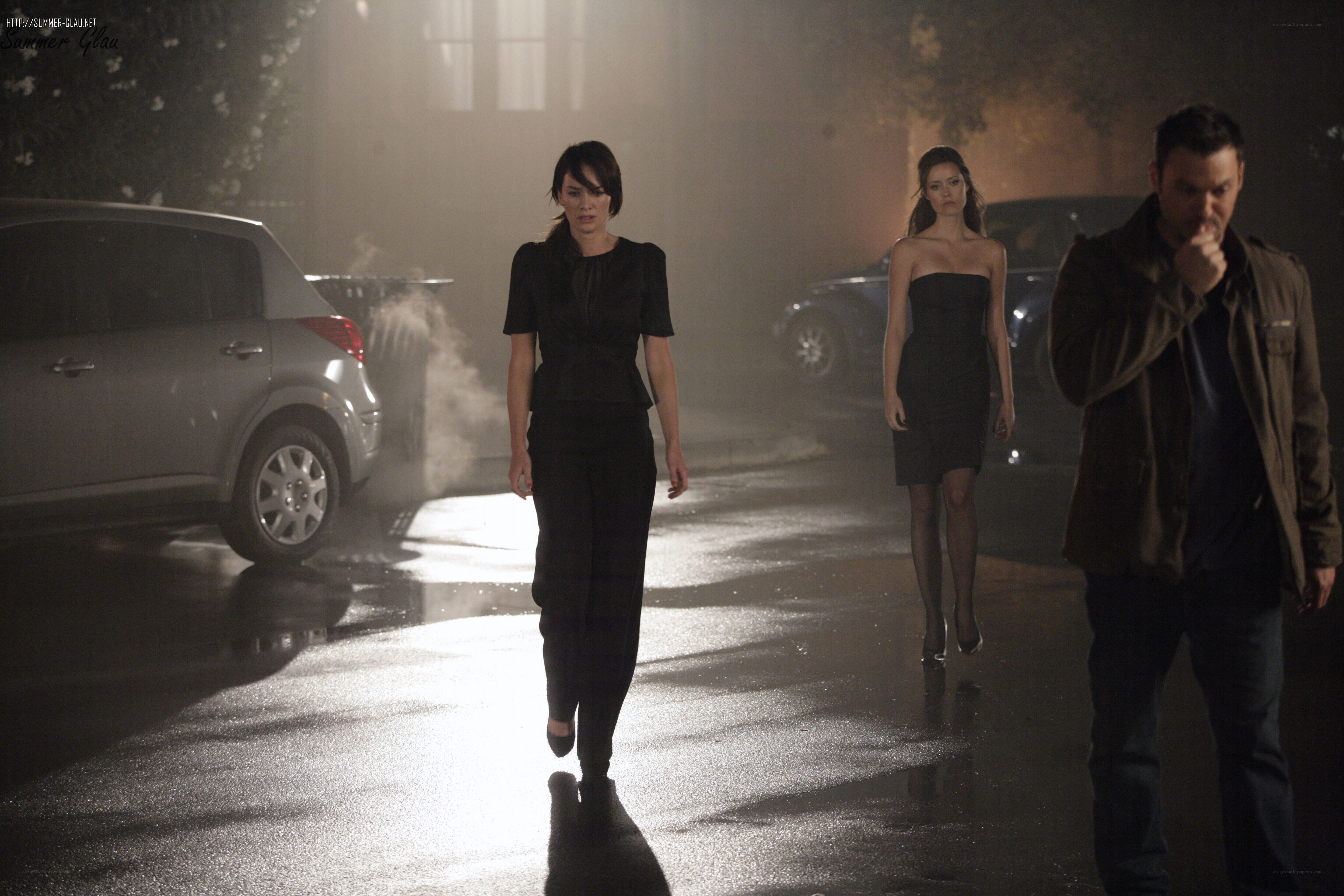 Three people walking at night