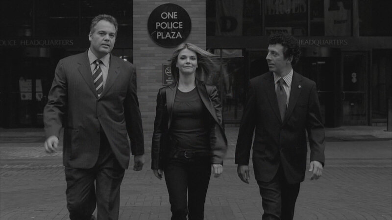 Three People Walking Outside — Black