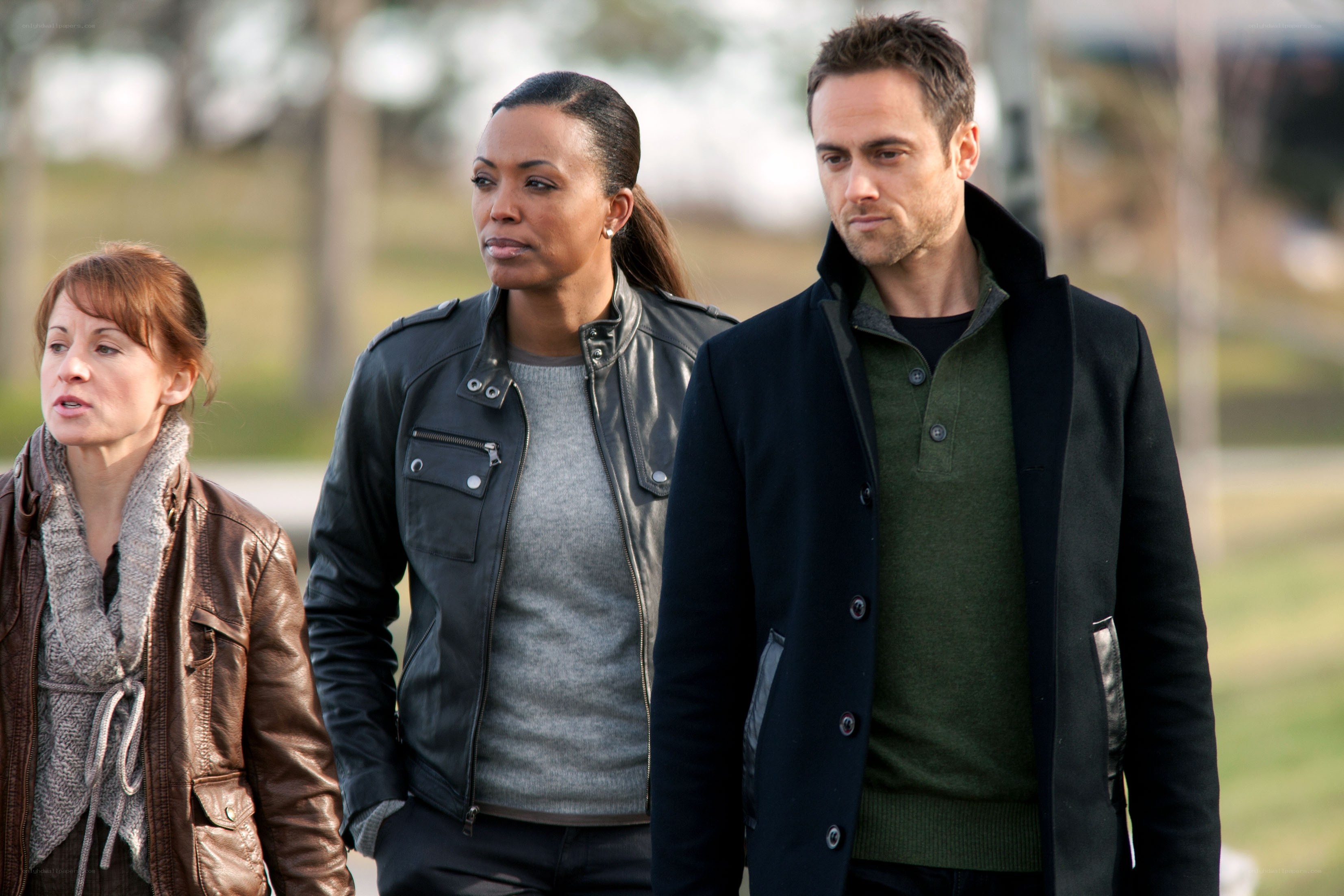 three people walking outside